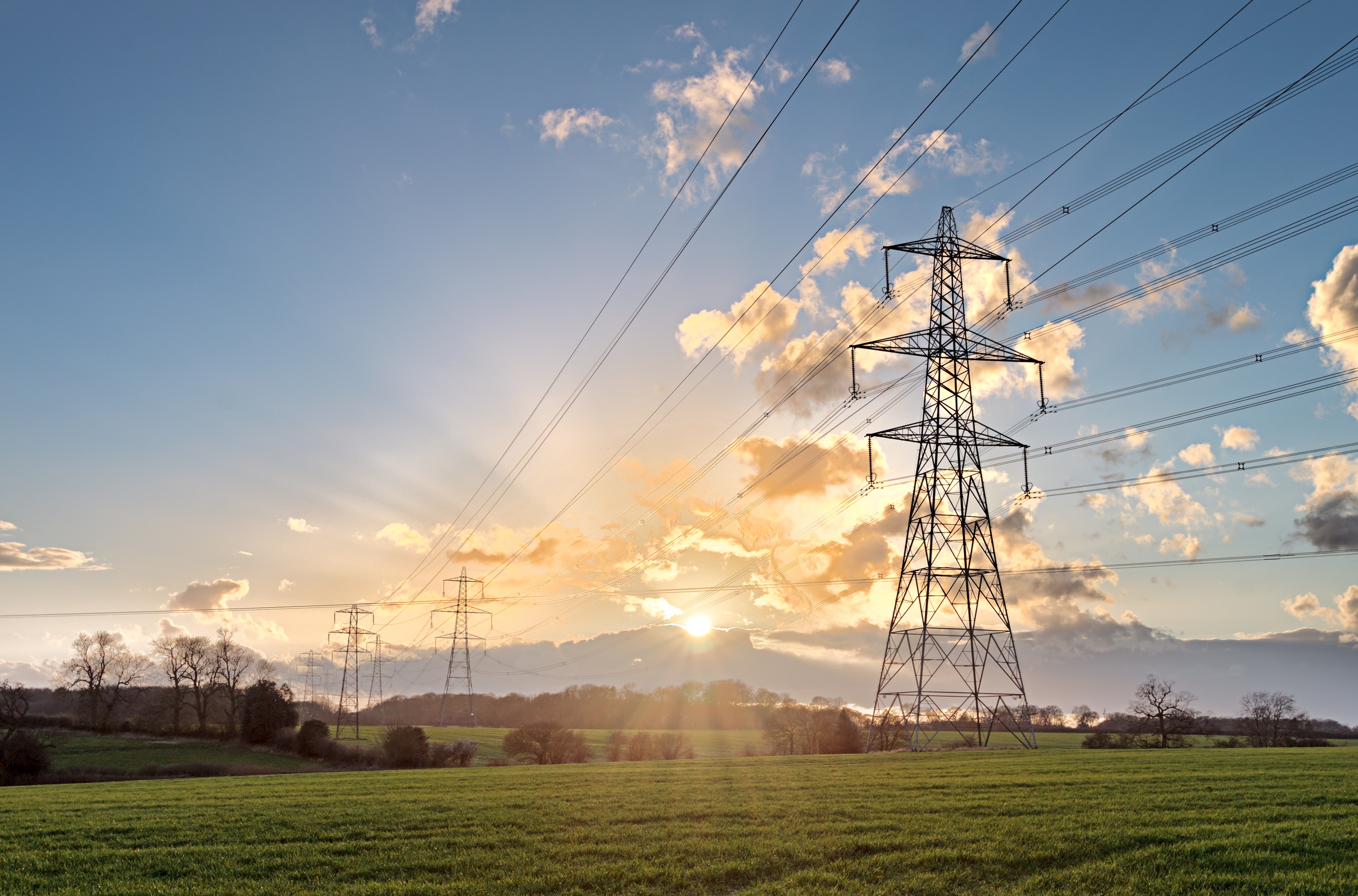 Photo of electricity pylons and cables crossing the countryside