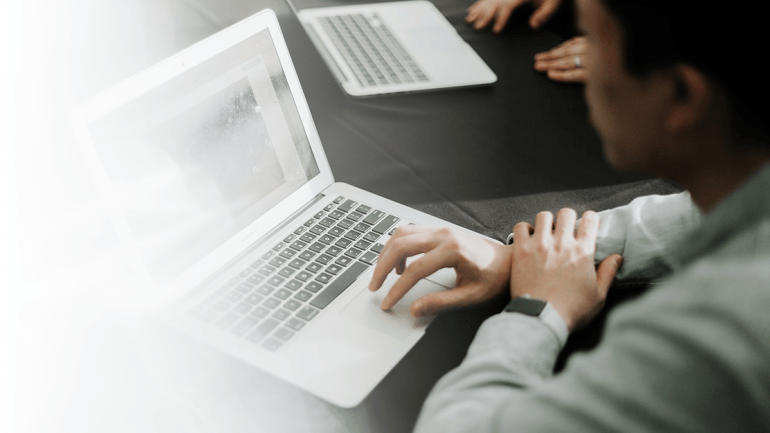 Photo of a man using a laptop